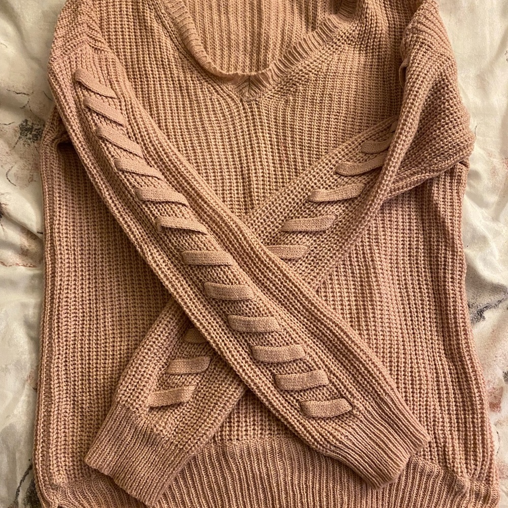 Pink sweater with ties on sleeves. Worn a few times very good condition